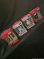 Front view of all four boxed ornaments