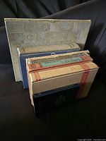 Front view of stacked books showing covers and spines