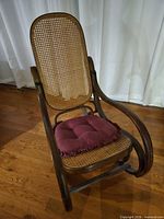 Front perspective of bentwood cane rocking chair with burgundy cushion