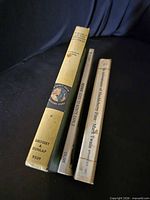 Spines of all three books showing titles and publishers