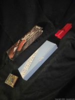 All four items laid out: Murad pack, Marlboro Trail Tags box, Virginia Slims tote bag box, Pressta roller