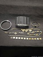 All seven bracelets laid out on black background