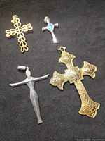 All four cross pendants on black background