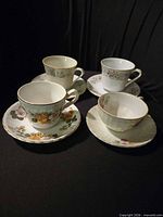 Overhead view of four teacups on saucers