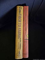 Spines of both hardcover textbooks visible