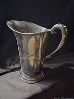 Front view of tarnished silver plated pitcher