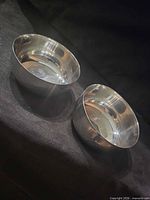 Two stainless steel bowls, top view