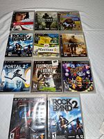 All eleven PS3 game cases laid out for identification