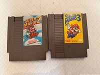 Front view of both NES cartridges showing titles and labels