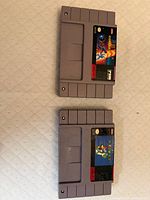 Front view of both SNES cartridges showing labels and overall condition