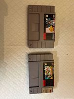 Front view of two SNES game cartridges: Super Mario All-Stars and Mega Man X