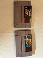 Top view of two SNES cartridges: StarFox and The Incredible Hulk