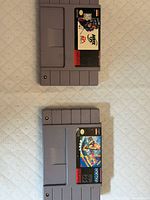 Front view of both SNES cartridges showing labels for NHL 98 and Dennis the Menace