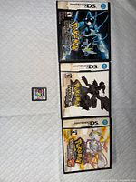 Three DS cases—Pokemon Black 2 cover (contains Platinum per seller), Pokemon White, Pokemon White 2—and loose Namco Museum cartridge