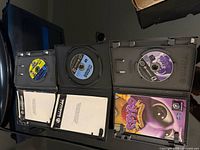 Interior view of the three open cases with discs and manuals