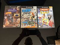 Front view of three GameCube game cases: Ratatouille, SSX On Tour, Nicktoons Unite
