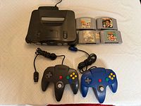 Top view of console, two controllers, four cartridges