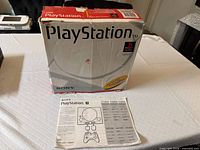 Front of PlayStation retail box with instruction sheet