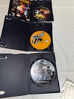 Open cases showing all three labeled discs