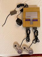 Console, two controllers, AC adapter, AV cable displayed