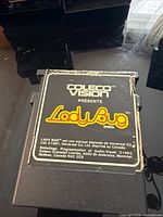 Front view of Lady Bug Atari (ColecoVision) cartridge showing label and wear
