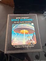 Front view of Atari Space Invaders cartridge showing label, artwork and model CX2612