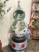 Front view of full fountain showing gourd shape, ivy design, and cascade tiers