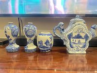 Front view of square blue and white porcelain teapot beside other items (not included)