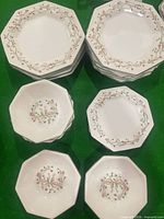 Stacks of dinner plates, salad plates and bowls showing pattern and octagonal shape