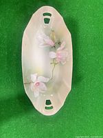 Top view of oval dish showing floral design and cutout handles