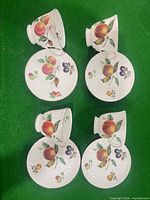 Front view showing fruit pattern on all cups and saucers