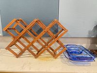 Wooden wine rack and stacked blue baking dishes
