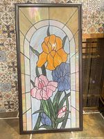 Full view of framed stained glass panel showing entire design and frame