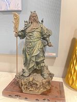 Full front view of Guan Gong statue on wooden base