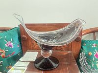 Side view showing overall shape, plum color foot, clear stem, and bowl profile