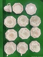 Overhead view showing multiple cup, saucer and plate stacks displaying pattern and octagonal shapes