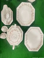 Top-view of platters, large bowl, gravy boat, tureen, shakers displaying pattern and shape