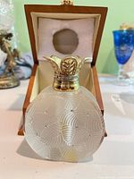 Front view of crystal perfume bottle inside presentation box