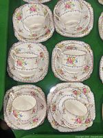 Entire set showing 6 cup-saucer-plate trios