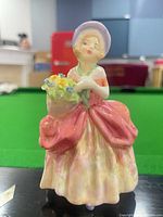 Front view of Royal Doulton Cissie figurine showing colors and pose