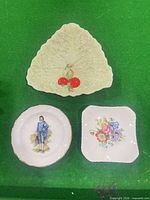 All three decorative plates on green background