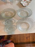 Overview of all five pressed glass dishes on table
