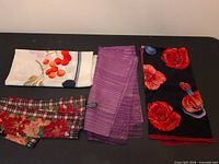 four folded scarves showing variety