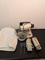 Full lot showing stand mixer with bowl, hand mixers, cover and attachments
