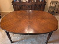 Top view of oval wooden dining table setup without leaves
