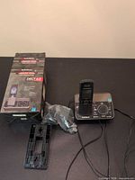 Box, handset on base, accessories visible