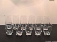 Group of 6 tall and 5 short clear glasses