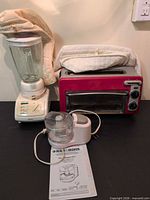 Krups blender, red toaster oven with top toaster, Black & Decker mini chopper and manual displayed together