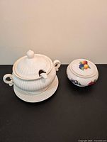 Tureen with lid on underplate and Teleflora covered bowl side-by-side