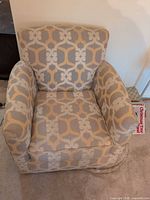 Front angled view of patterned swivel armchair